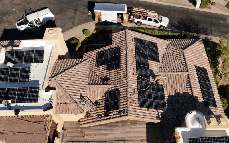 solar panels on rooftop with workers