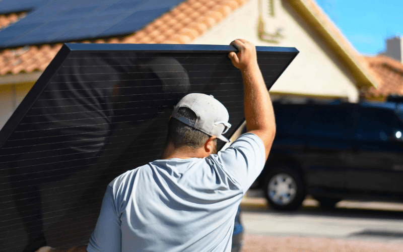 sun valley solar worker carrying panel